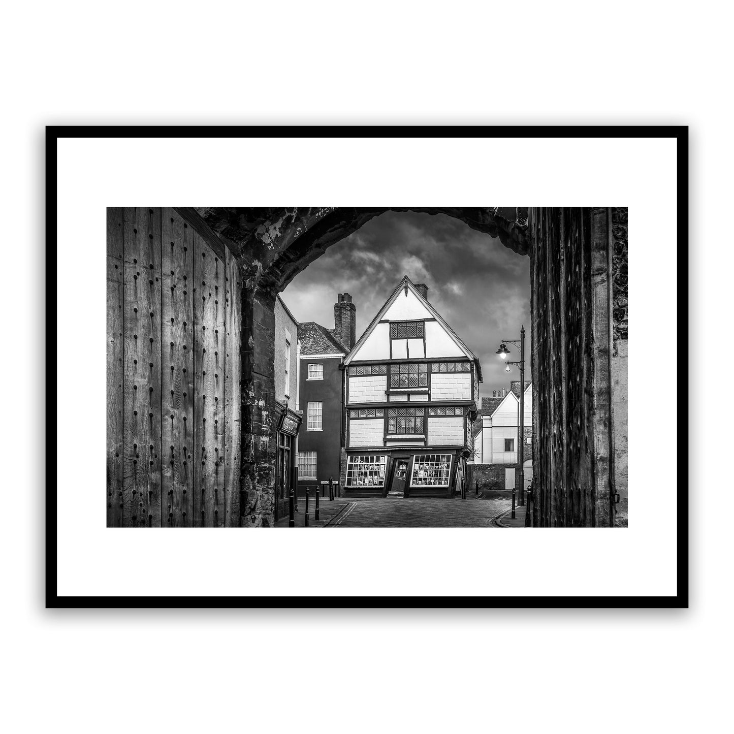 Crooked House, King Street, the King’s Mile, Canterbury, Kent, England. Framed within the gates of the historic King's School, the Crooked House is one of Cantebrury’s most unique and distinctive landmarks. Built in the 17th Century, this wonky house bulges and leans over the street below. Fine art photography print for sale.