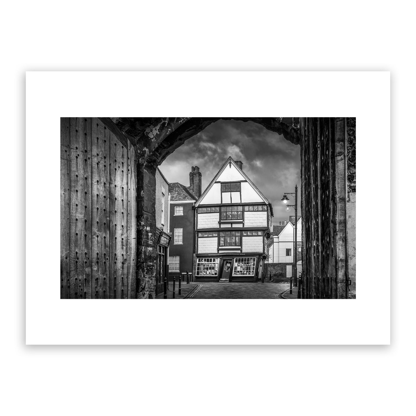 Crooked House, King Street, the King’s Mile, Canterbury, Kent, England. Framed within the gates of the historic King's School, the Crooked House is one of Cantebrury’s most unique and distinctive landmarks. Built in the 17th Century, this wonky house bulges and leans over the street below. Fine art photography print for sale.