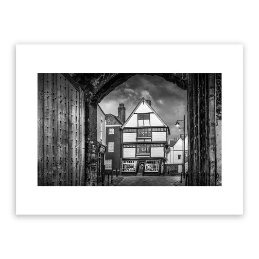 Crooked House, King Street, the King’s Mile, Canterbury, Kent, England. Framed within the gates of the historic King's School, the Crooked House is one of Cantebrury’s most unique and distinctive landmarks. Built in the 17th Century, this wonky house bulges and leans over the street below. Fine art photography print for sale.