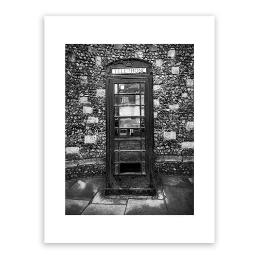 Historical telephone kiosk on the King's Mile, Canterbury, Kent, England. Designed in 1935 by Sir Gilbert Scott, introduced in 1936 to mark the jubilee of George V. The crown appearing above the door was the traditional Tudor crown. These cherished phone boxes in Canterbury are actually considered listed buildings! Fine art black and white photography print for sale.