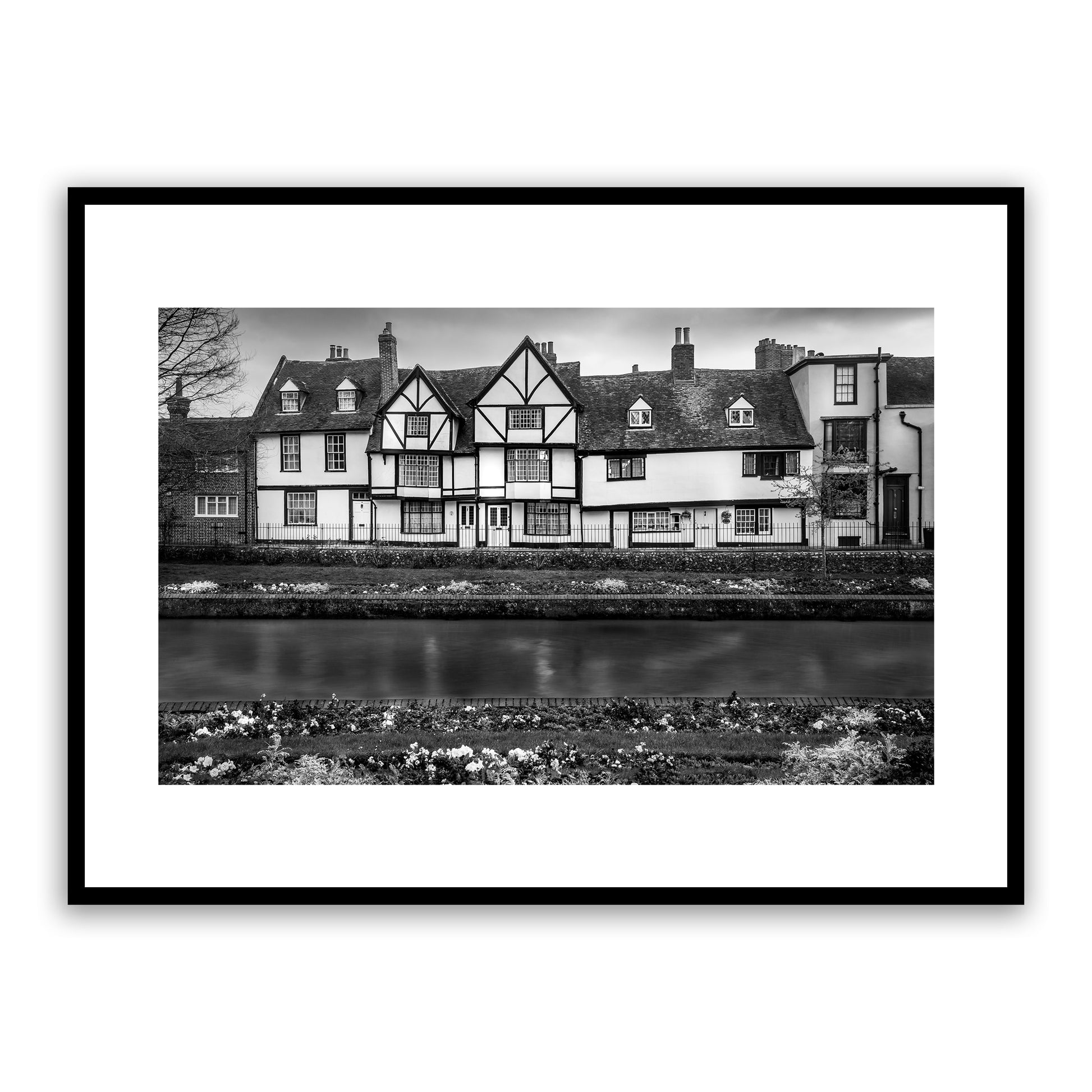Westgate Grove on the Stour. Traditional 16th century row of houses on the banks of the river Stour seen from the beautiful Westgate Gardens, Canterbury, Kent, England. Fine art black and white photograph print for sale.