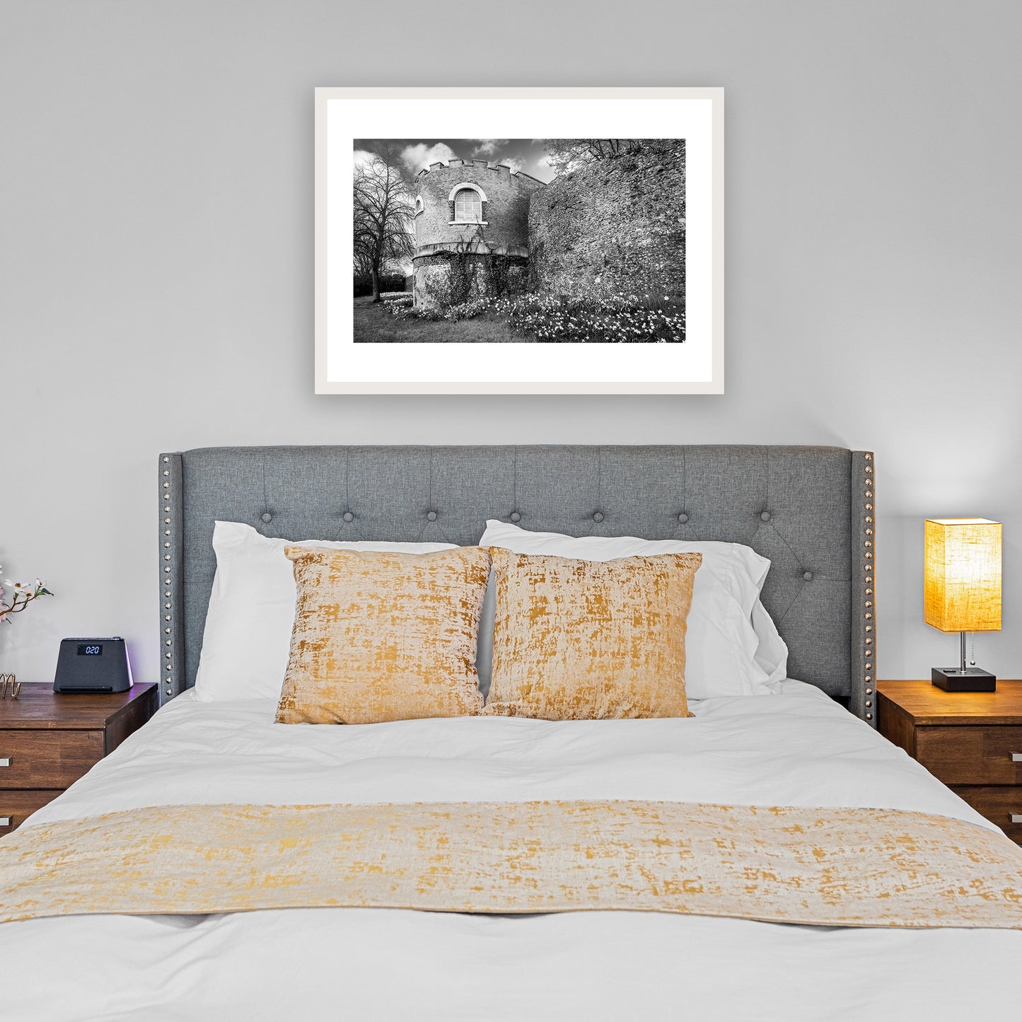One of the distinctive half-circular or 'horse-shoe' medieval towers on Canterbury’s ancient city wall, surrounded by flowering daffodils in early spring. Medieval City, Canterbury, Kent, England. Fine art black and white photography print for sale.