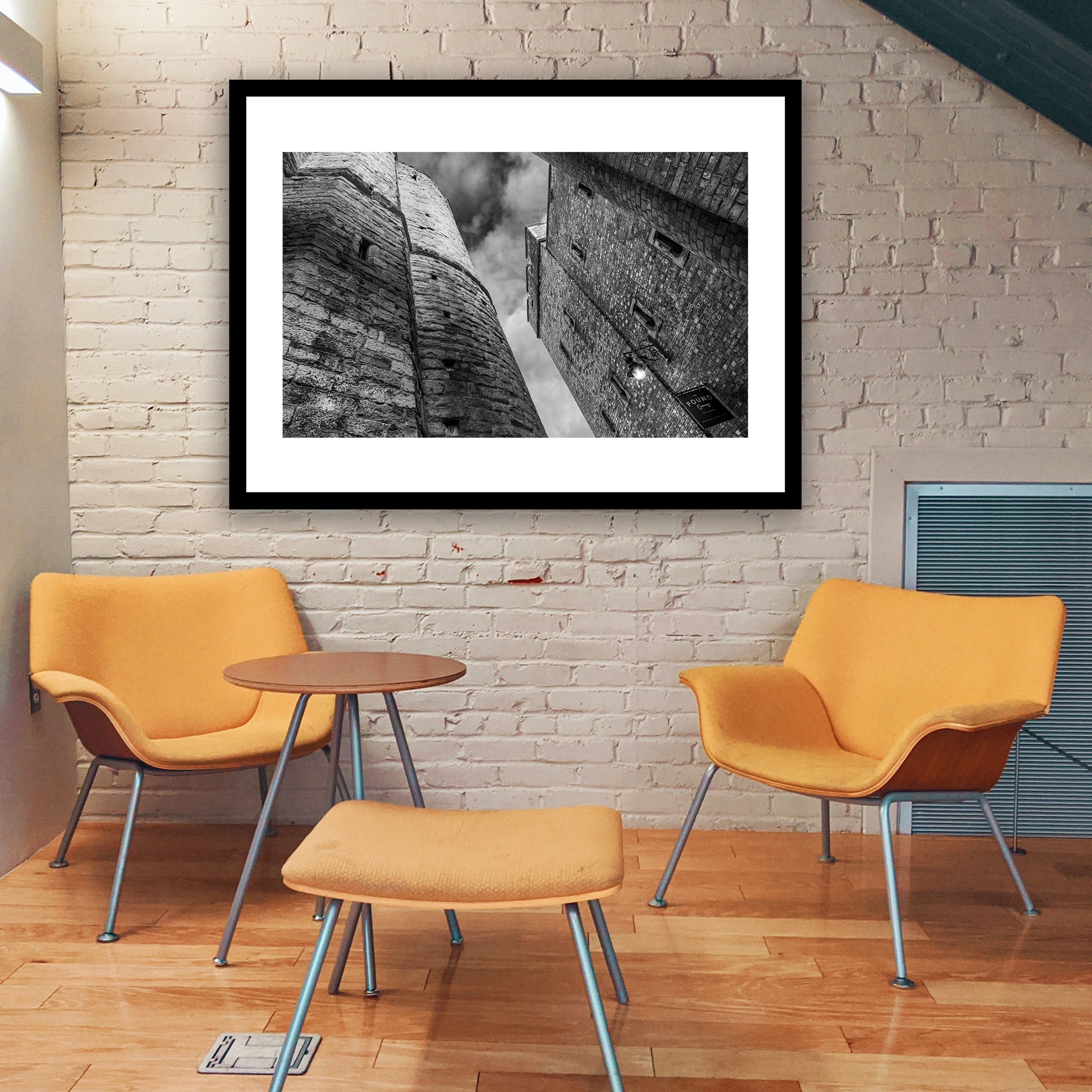 The Pound, One Pound Lane, Canterbury, Kent, England. Alleyway between one Pound Lane (former Victorian gaol now bustling bar and restaurant) and the medieval iconic Westgate Towers. Fine art black and white photography print for sale.